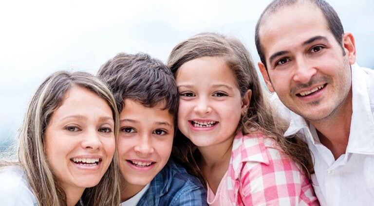 Smiling family portrait with two children.